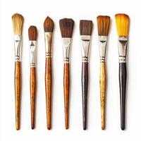 Various paintbrushes arranged in a row showcasing different sizes and bristle types for artists and craft enthusiasts photo