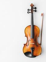 Elegant wooden violin with bow displayed against a plain white background highlighting its craftsmanship and intricate details photo