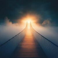 Misty suspension bridge leading towards a bright horizon at dawn photo
