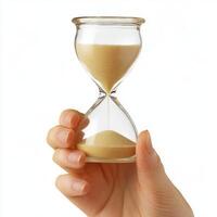 Sand timer held in hand indicating the passage of time during a quiet moment of reflection photo
