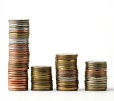Stacks of coins arranged in various heights demonstrating financial growth and savings potential in a minimalistic setting photo