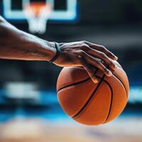 Close-up of a hand gripping a basketball before a crucial shot during an intense game at a sports arena photo