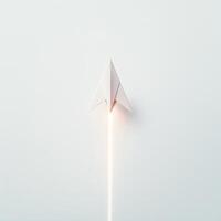 Paper airplane takes flight against a minimalistic background enhancing the sense of motion photo