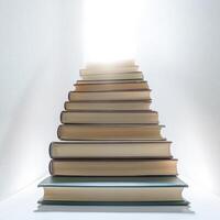 Books arranged in a staircase formation leading towards a bright light photo