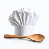 Chef hat and wooden spoon represent culinary arts in a creative setup photo