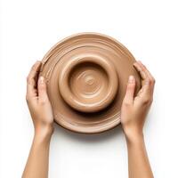 Hands shaping clay on a pottery wheel in a creative studio environment photo