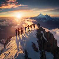 Group of climbers celebrating at sunrise on a snow-covered mountain peak in the Himalayas photo