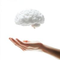 Hands reach towards a floating cloud-like representation of a brain in a bright, minimalist setting photo
