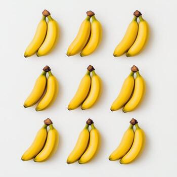 Bright yellow bananas arranged in a grid pattern on a white background photo