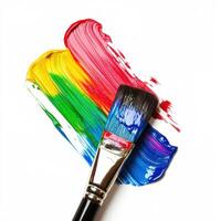 Vivid paint strokes and brush create a colorful artwork on canvas in a creative studio setting photo