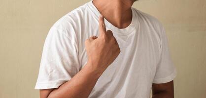 Young man showing gesture DEAF in sign language photo