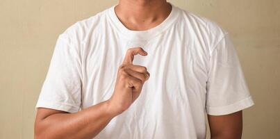Young man showing letter X on sign language photo