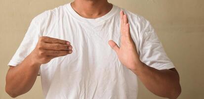 Young man deaf mute man showing number 500 using sign language photo