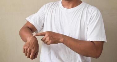 Young man making TIME gesture using American sign language photo