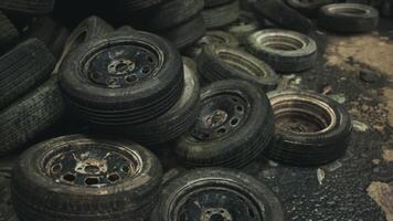 Old and worn out tires scattered on the ground in a neglected storage area video