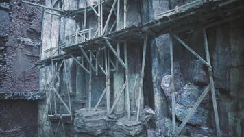 Ancient rock structures with wooden scaffolding in a mountainous area video