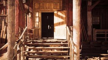 Wooden steps leading to an open door of an old rustic building during daylight video