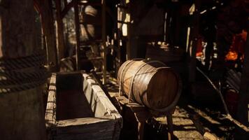 Wooden barrel and trough in rustic workshop during sunny afternoon light video
