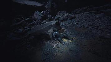 Knight lying lifeless in a dark cave surrounded by rocks and shadows video