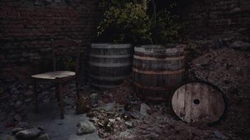 Abandoned space with barrels and a broken chair in overgrown environment video