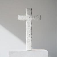 A white cross is standing on a white pedestal photo