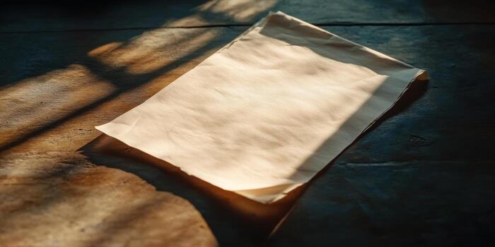 Sunlit Blank Paper on Rustic Wooden Table with Soft Shadows and Warm Tones photo