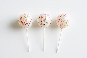 Colorful Polka Dot Cake Pops on White Background photo