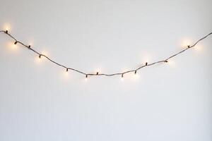 A string of lights hanging from a wall photo