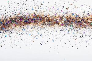 A line of colorful glitter is spread out on a white background photo