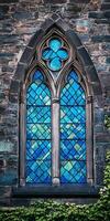 A blue stained glass window with a stone arch photo