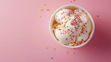 A bowl of ice cream with rainbow sprinkles on top photo