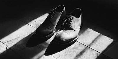 Classic Black Leather Shoes in Dramatic Monochrome Lighting on Tiled Floor photo