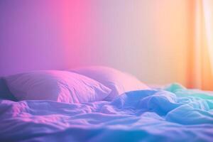 A bed with two pillows and a blanket photo