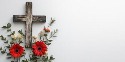 A cross is surrounded by flowers and leaves photo