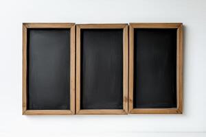 Three wooden frames with black chalkboards photo