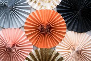 A collection of paper fans with gold and black designs photo