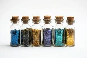 Colorful Glitter in Glass Bottles with Cork Stoppers Arranged in a Row on a White Background photo