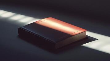 A book is laying on a table with the sun shining on it photo