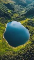 A large body of water surrounded by trees and mountains photo