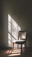A chair is sitting in front of a wall photo