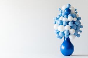 A blue vase with white balloons in it photo