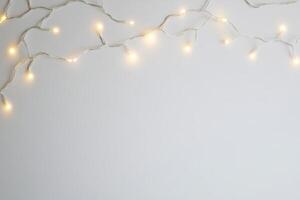 Warm White Fairy Lights on Minimalist White Background for Festive and Cozy Atmosphere photo