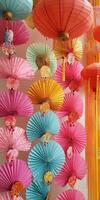 A colorful display of paper fans hang from the ceiling photo