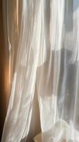 A white curtain with a pattern of squares and triangles photo