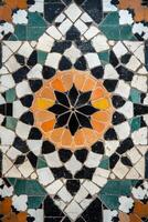 A colorful mosaic tile floor with a black center photo