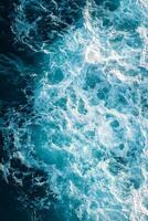 The water is blue and has white bubbles photo