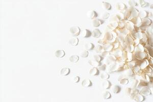 A pile of white flower petals on a white background photo