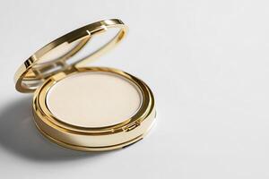 Compact powder with a gold trim, isolated on a white background for a luxury feel. photo