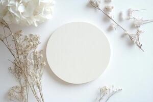 Minimalist Flat Lay with Dried Flowers and Round Wooden Plate photo