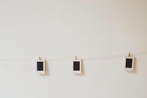 Three cell phones hanging on a clothesline photo
